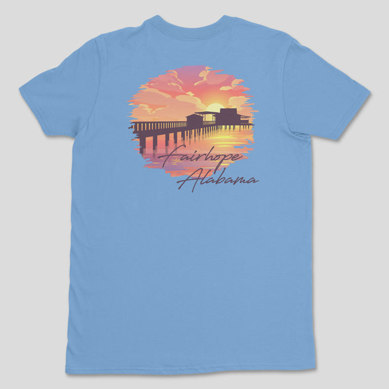 Introducing the Fairhope Sunset - Tee: a light blue t-shirt showcasing a stunning sunset scene at the Fairhope Pier with the text "Fairhope Alabama" beneath the image.