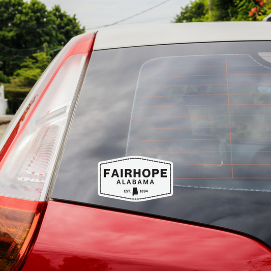 A car with a weatherproof Fairhope Heritage - Sticker on the rear window.